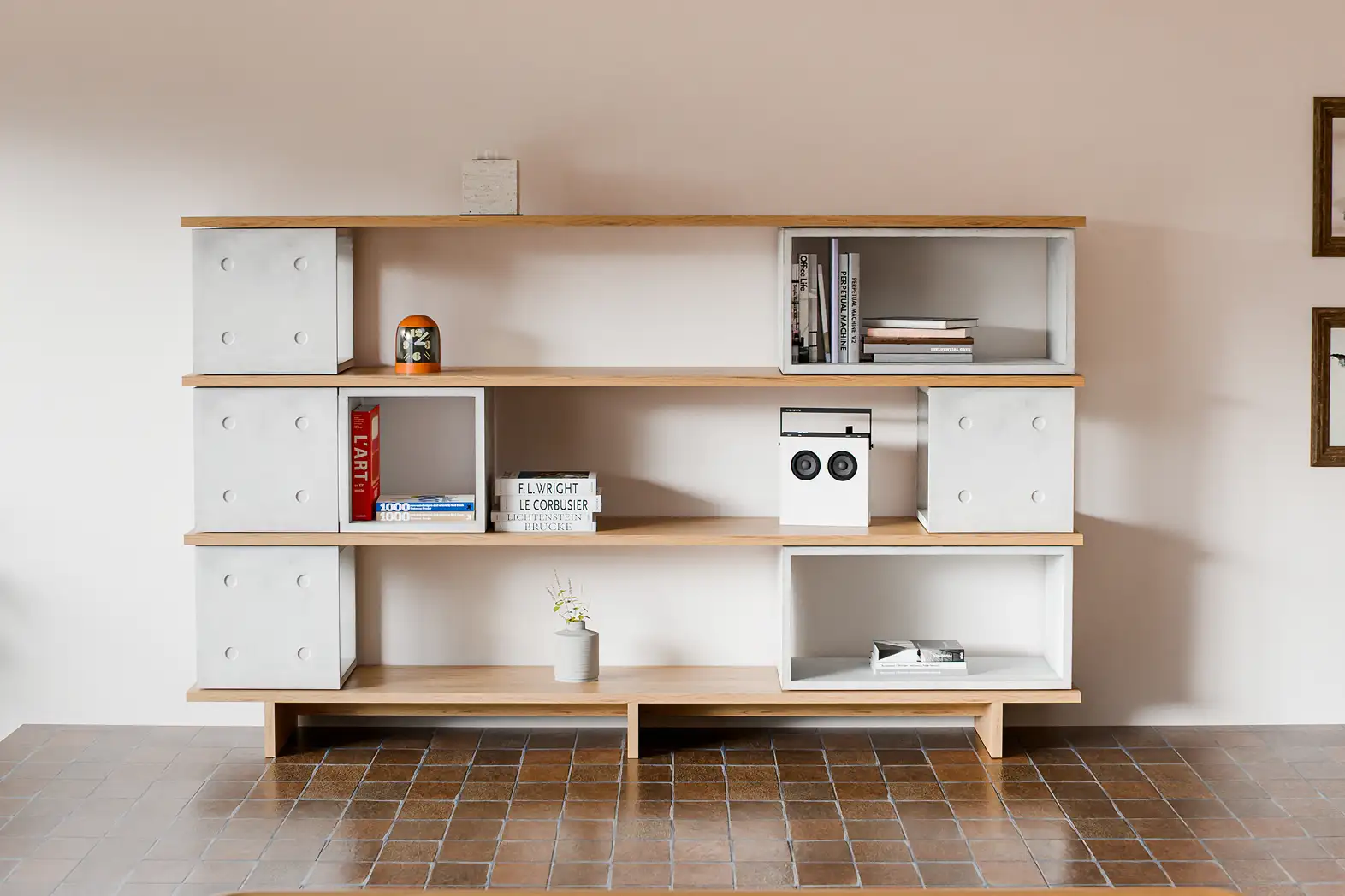 Dice concrete system on a wood shelf with design and architecture books — Lyon Béton